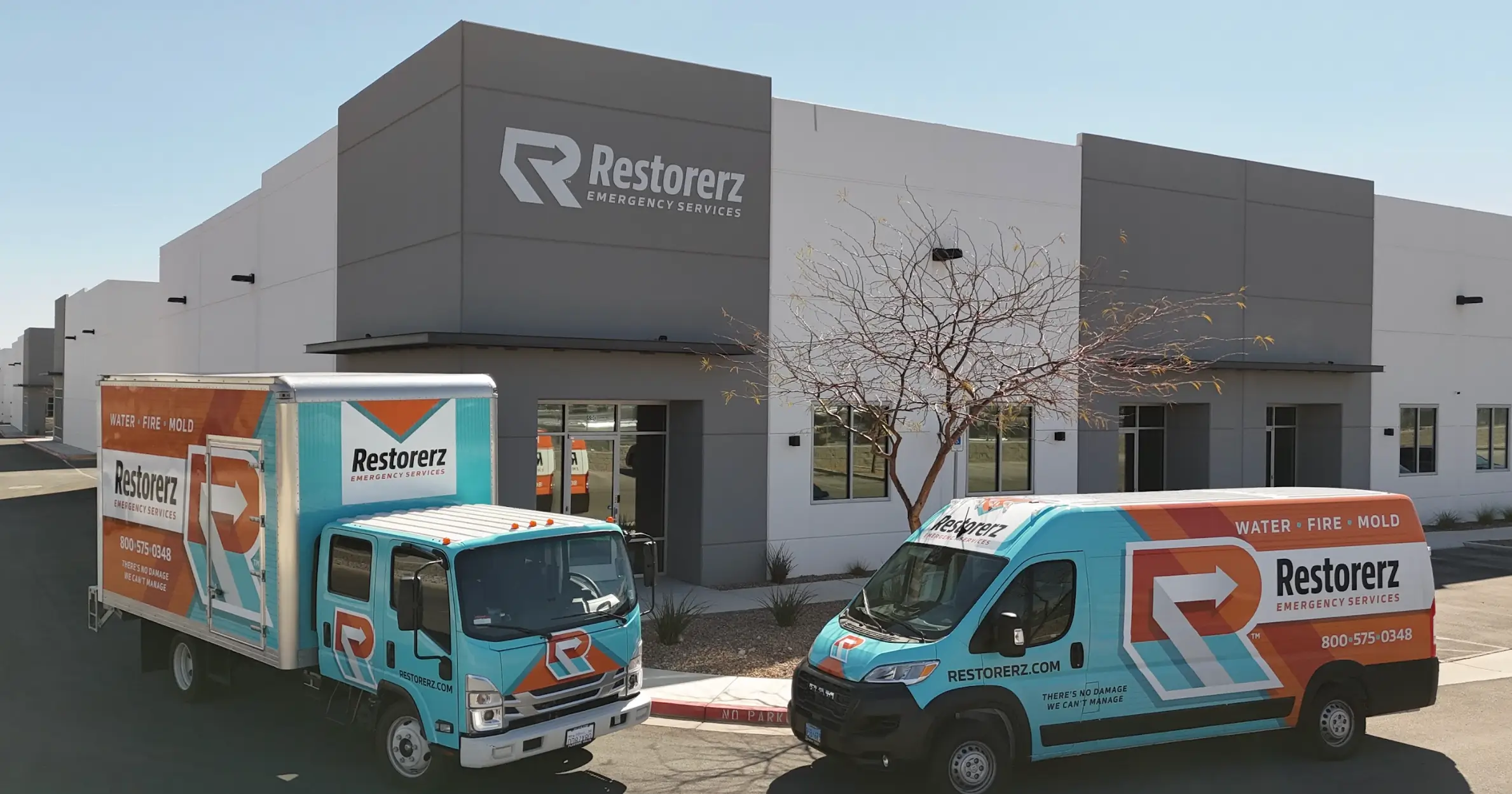 Two Restorez Emergency Services vehicles are parked outside of Restorerz Emergency Services office