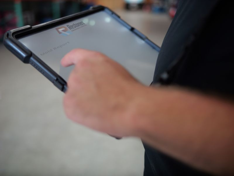 A person holding a tablet.