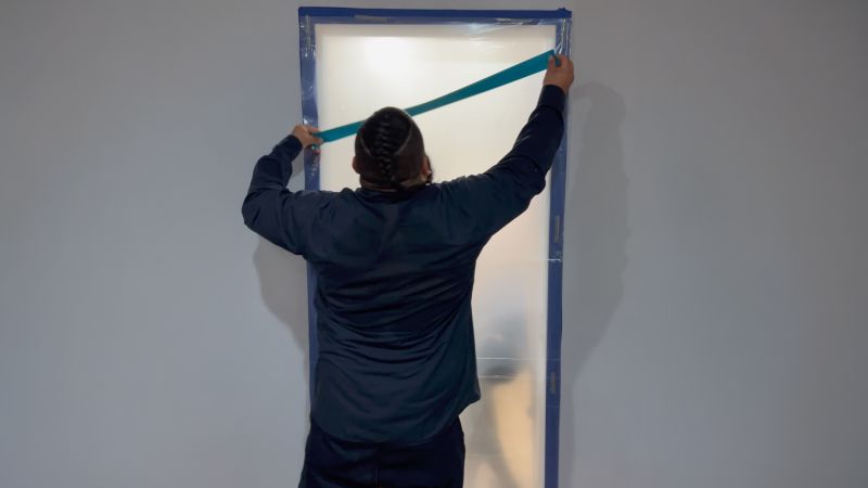 A person measuring a door.